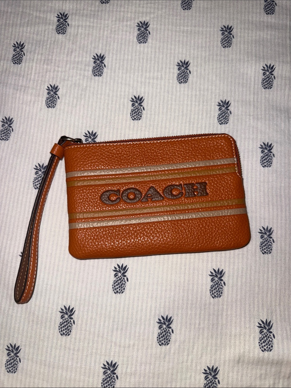 COACH Orange Pebbled Leather Wristlet with Tan Stripe Detail. BRAND NEW WITH TAG
